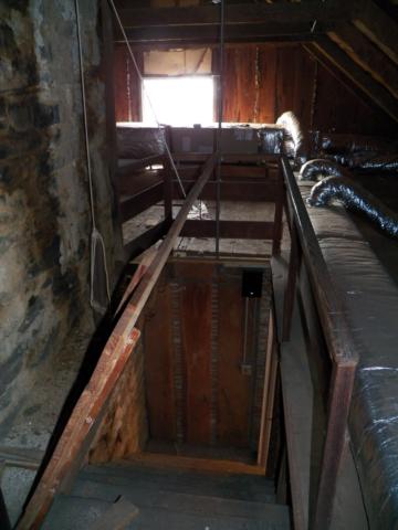 Attic-stairwell-looking-down-to-second-floor-entry-in-upstairs-bathroom.jpg