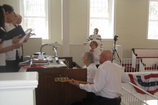Organist Louise Burr, choir director, guitarist, video recorder at 4-11-15 program.jpg